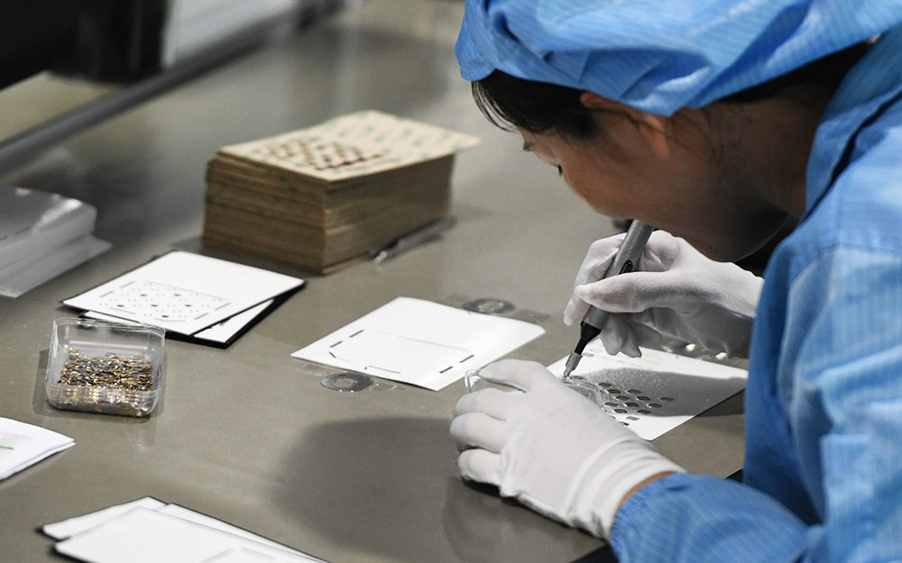 Worker Assembling Domes By Hand